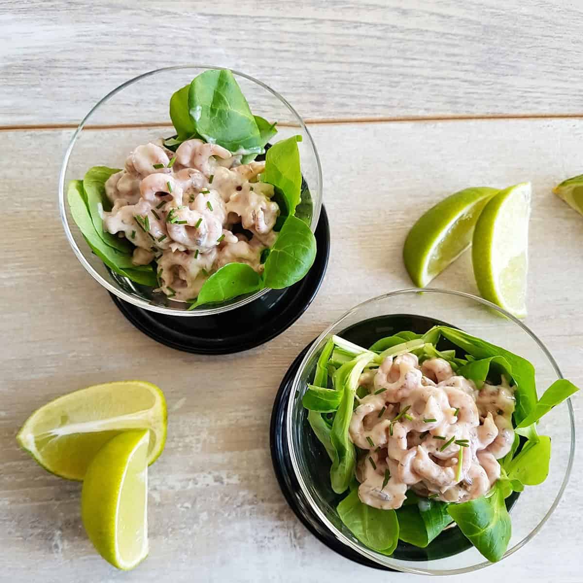 Shrimp cocktail cups: glasses with a simple green leaf salad and a classic prawn cocktail.