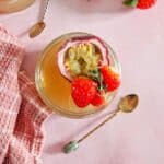 Tea jelly in a glass, served with passion fruit and fresh strawberries.