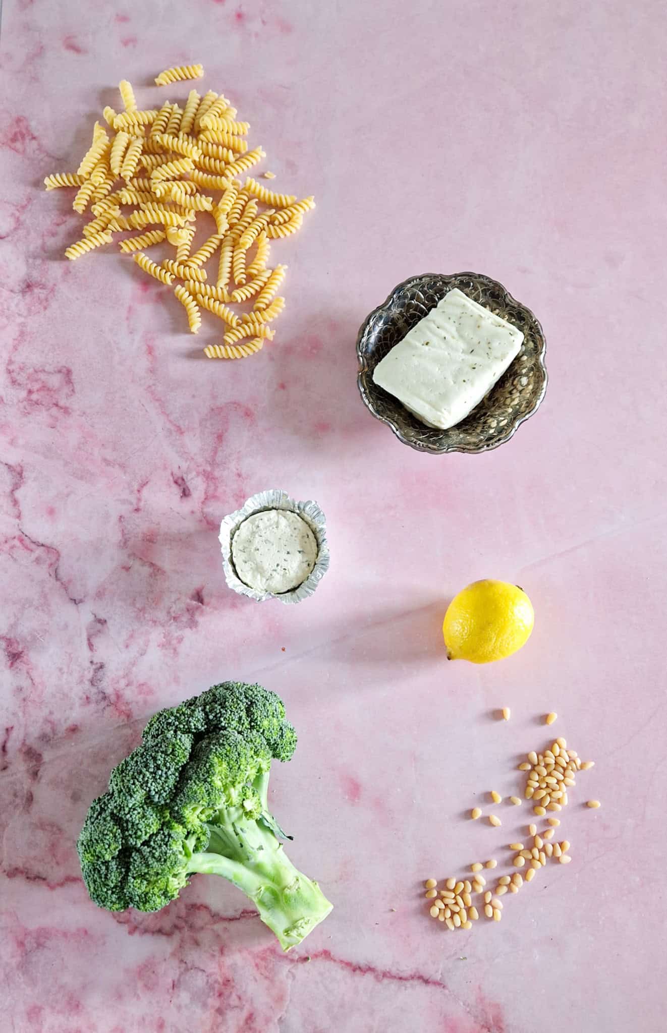 The ingredients to make halloumi pasta with Boursin are pasta, halloumi, boursin, lemon, pine nuts, and broccoli.