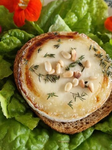 Baked goat cheese, drizzled with honey and served with fresh thyme and toasted pine nuts.