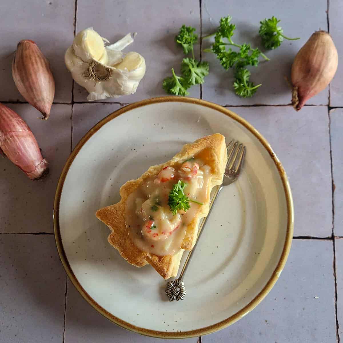 Shrimp Ragout in a Christmas Tree shaped Puff Pastry Shell, surrounded by fresh ingredients.