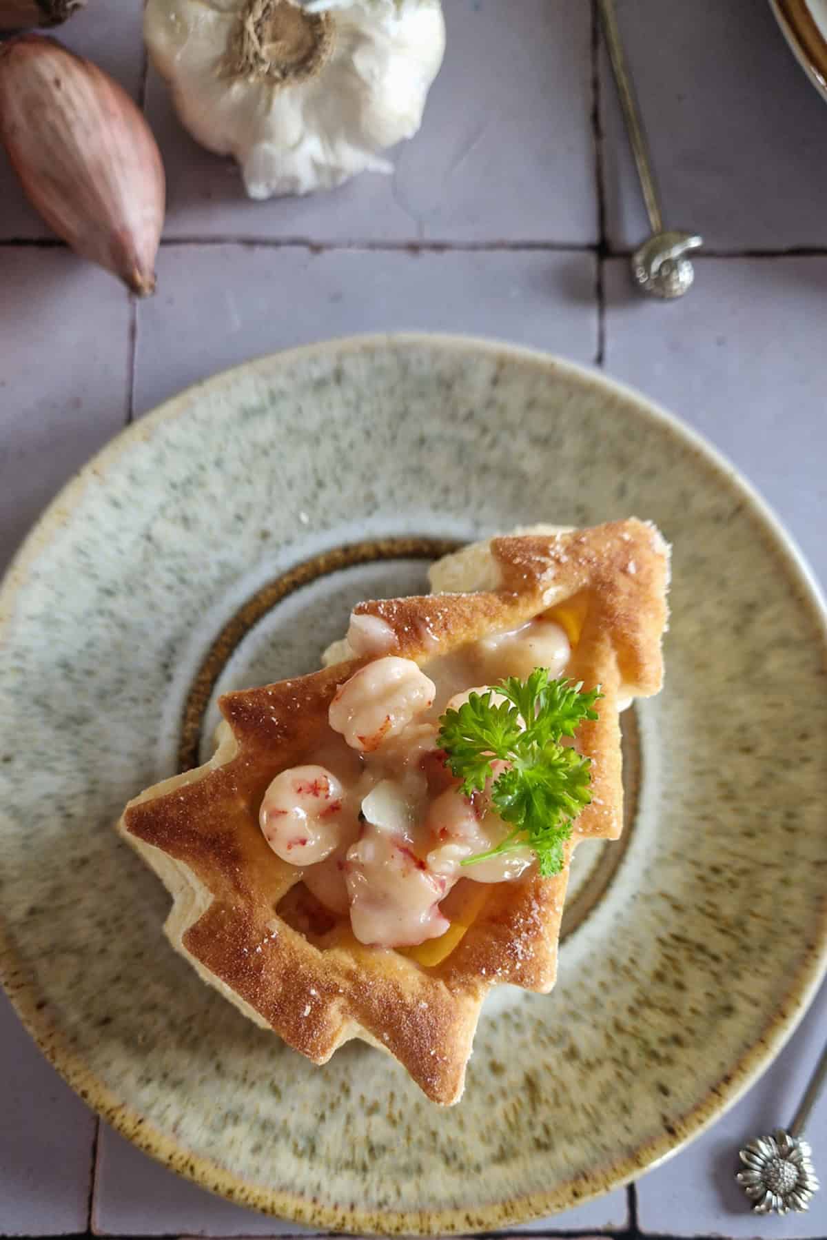 Close-up of a shrimp vol au vent in the shape of a Christmas tree.