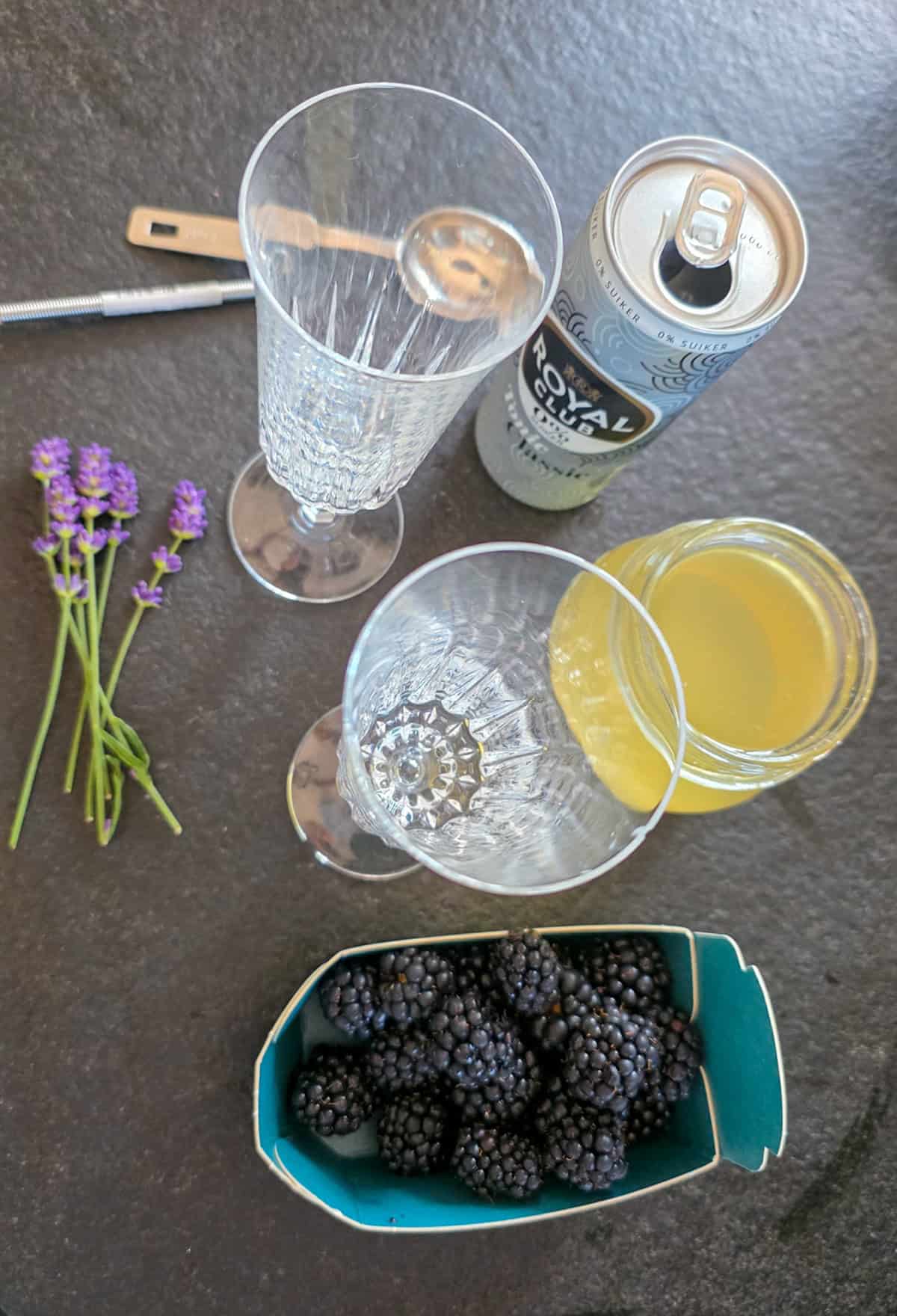 The ingredients to make a lavender mocktail with blueberries.