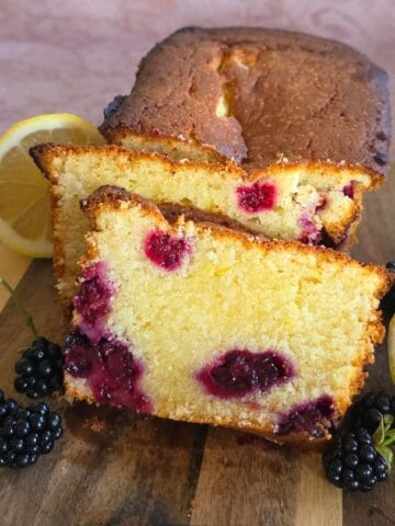 A freshly baked blackberry pound cake, sliced so you can see the inside of the cake.
